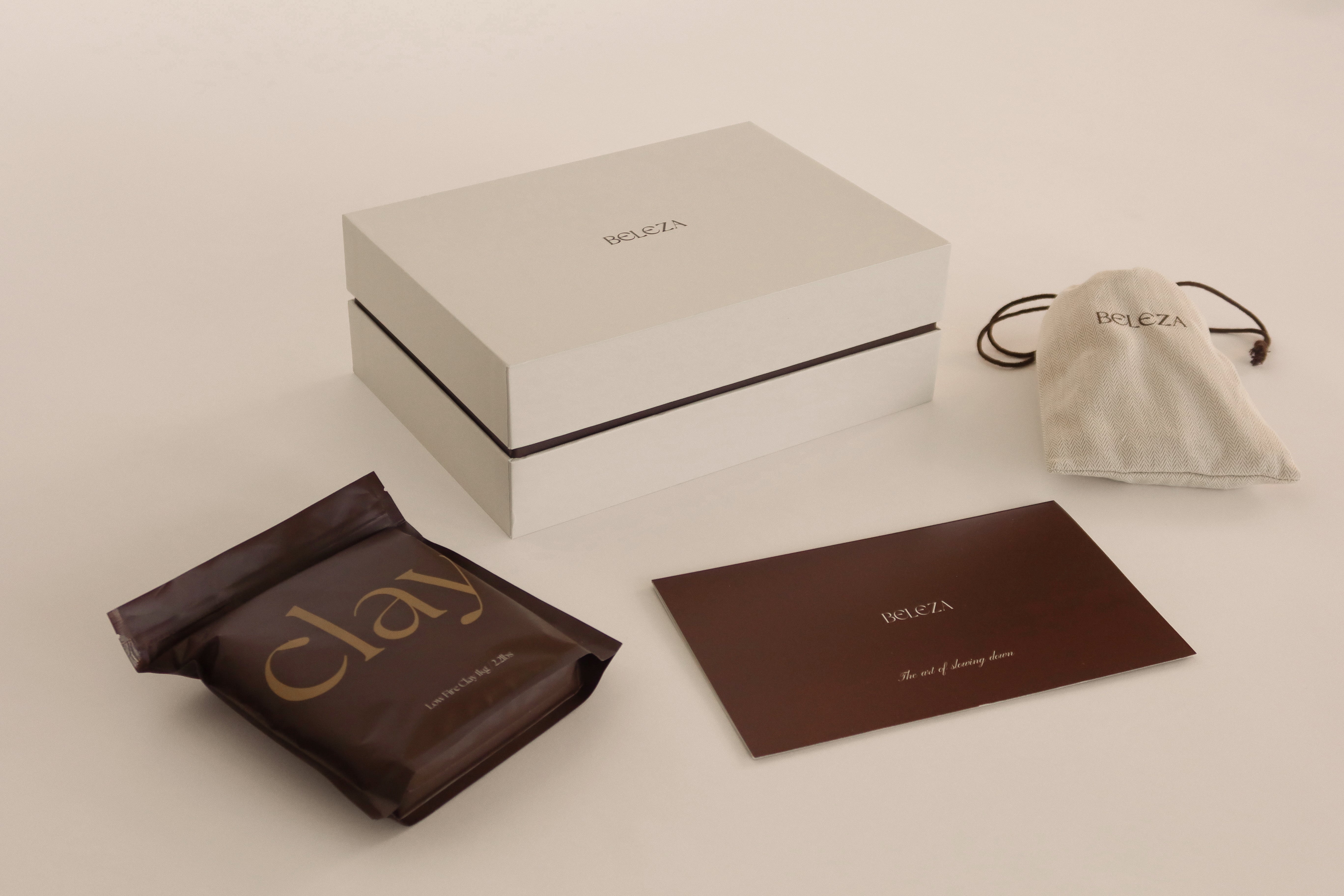 Beleza Pottery Kit box, clay bag, tool bag, and guide brochure on display.