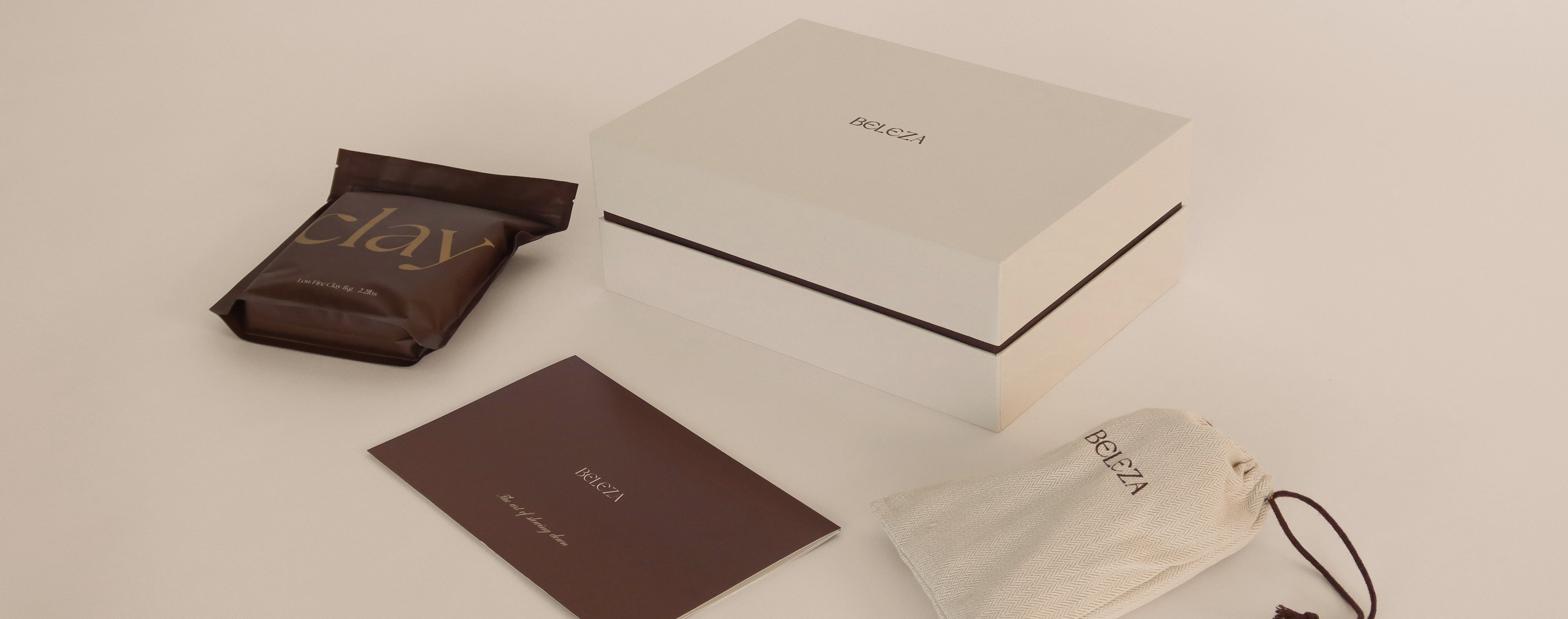 Beleza Pottery Kit photoshoot image showing box, clay bag, tool bag, and guide brochure.